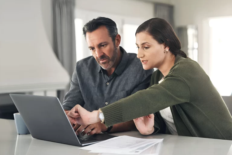 mature-couple-laptop-finance-documents-house-mortgage-loan-home-insurance-stock-market Image description